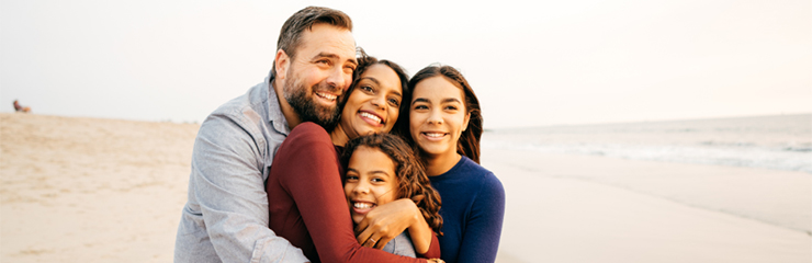 Family hugging on a beach