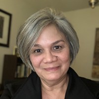 Jackie Ferrado from WA529 is wearing a black long sleeve top and is shown smiling into the camera